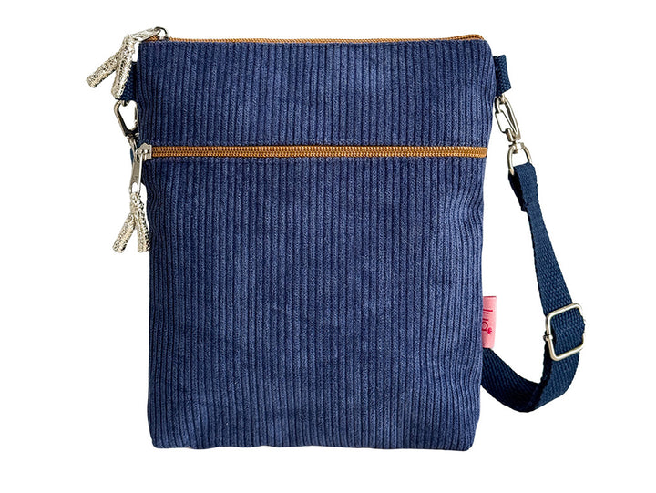 A navy blue corduroy crossbody bag with a top zipper, a horizontal zippered pocket, and a matching adjustable shoulder strap, shown against a plain white background.