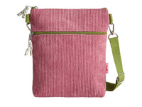 A pink corduroy crossbody bag with an olive green zipper and a matching green webbing strap, shown against a plain white background.