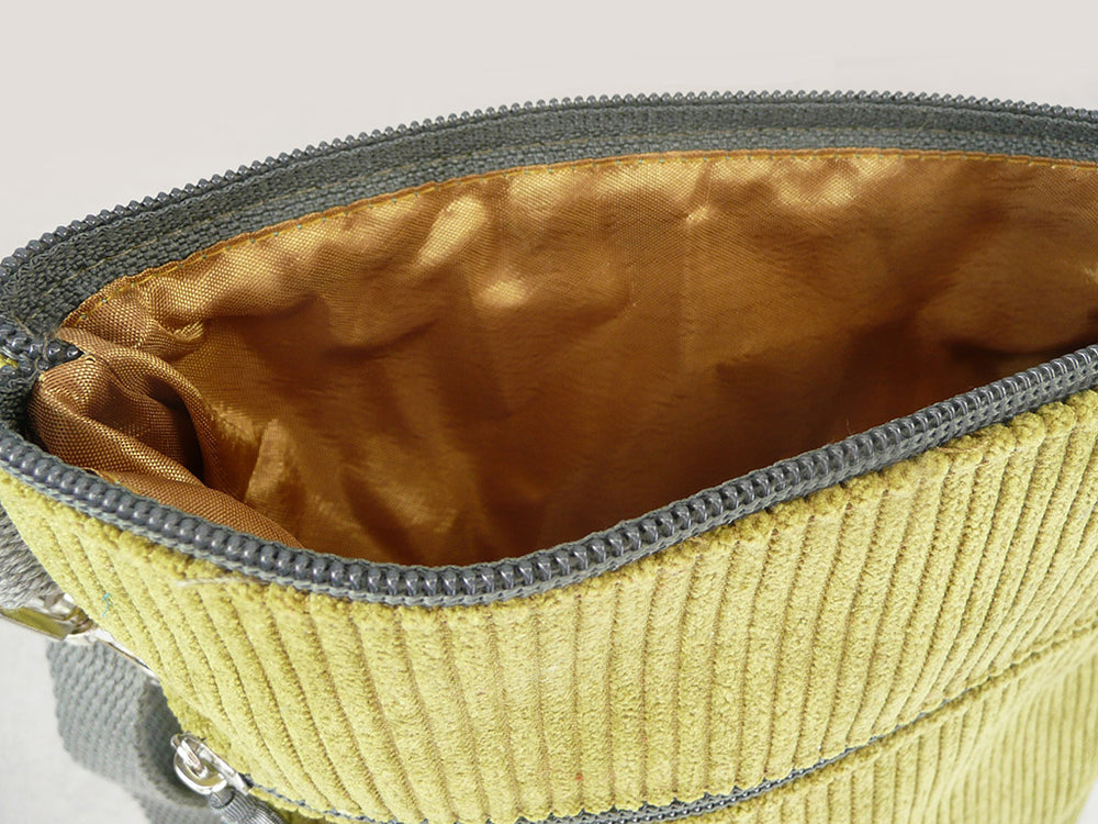 Close up of satin gold lining of a green corduroy bag