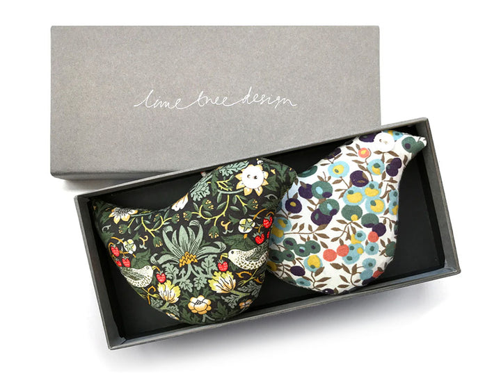 2 lavender bags in the shape of birds in Liberty print fabrics in a grey box