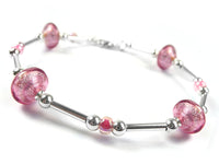 A silver beaded bracelet featuring three Murano pink glass beads and three smaller pink glass beads, displayed on a clean white background.