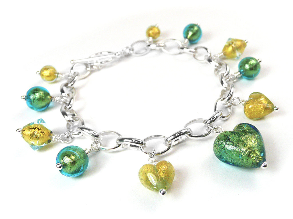 A silver chain bracelet featuring dangling heart and round glass beads in vibrant green, yellow, and teal, displayed on a clean white background.