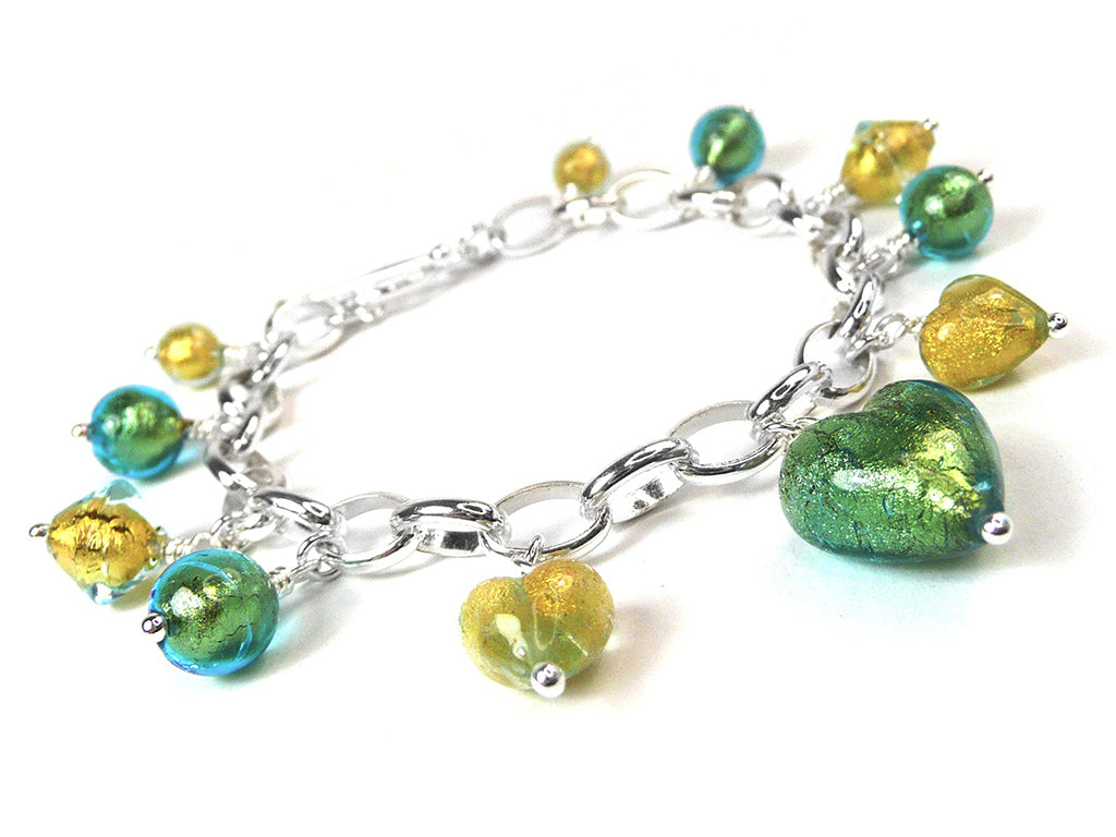 A silver chain charm bracelet featuring green and yellow heart-shaped glass beads and smaller metallic beads, displayed on a clean white background.