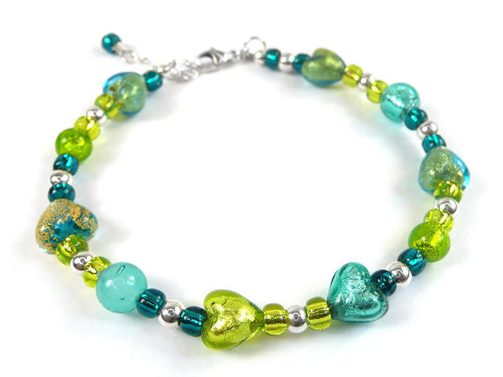 A beaded bracelet featuring a mix of turquoise, lime green, and metallic silver beads, with one prominent textured gold-and-blue glass bead, displayed on a clean white background.