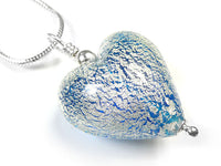 A heart-shaped glass pendant necklace with a textured blue and silver crackled pattern, suspended from a silver chain on a white background.