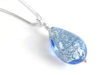 Teardrop-shaped blue pendant with silver chain on a white background