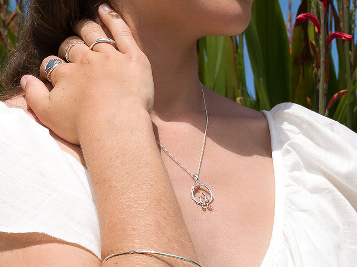 Lady wearing a pendant with 2 cats and the moon