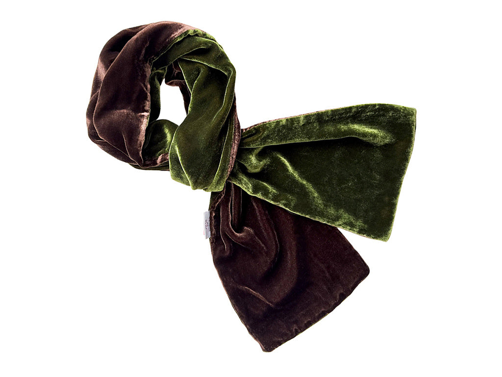 A velvet scarf in a two-tone design of dark brown and olive green, styled in a loose knot on a plain white background.