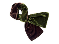 A velvet scarf in a two-tone design of dark brown and olive green, styled in a loose knot on a plain white background.