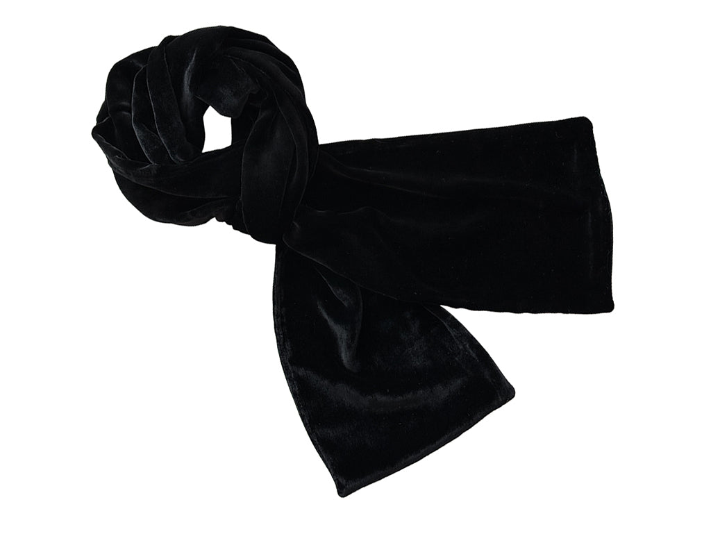 A black velvet scarf, styled in a knot, shown against a plain white background.
