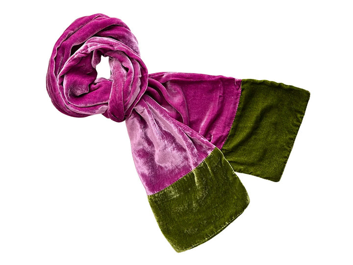 A plush velvet scarf in a colour-blocked design, featuring a magenta-purple section and an olive green section, shown on a plain white background.