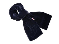A dark navy blue velvet scarf, styled in a loose knot, shown against a plain white background.